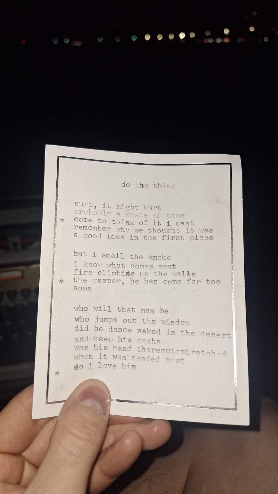 a typewritten poem held by a hand